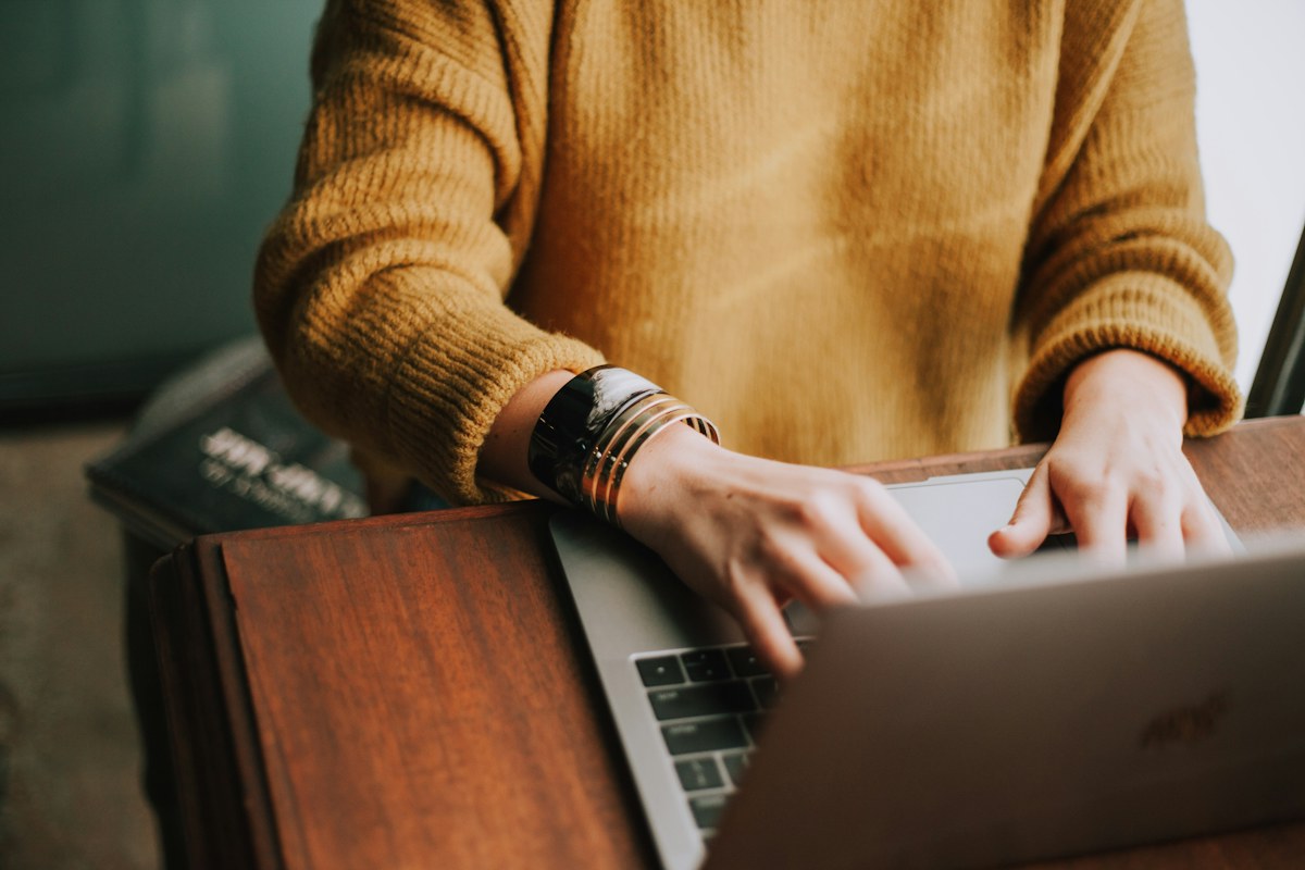 A person reviewing media carefully on a laptop