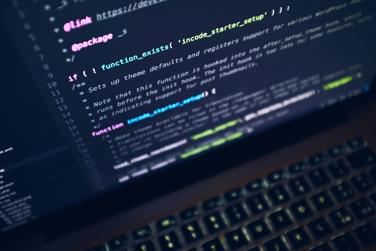 A close-up of a laptop displaying a search and code interface